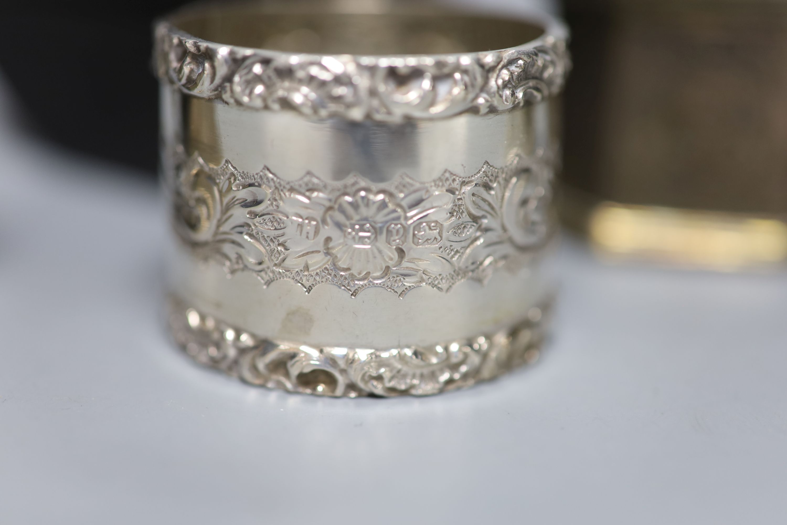 A cased late Victorian silver napkin ring, one other similar pair and a later silver napkin ring